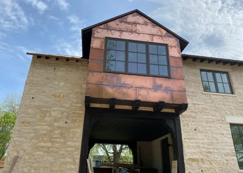 Copper metal panel facade on a stone building for Roof Repair in Piedmont